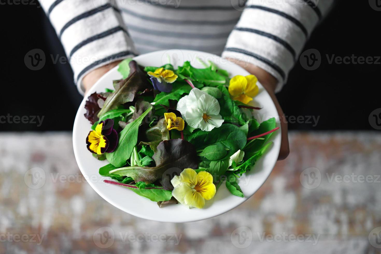 Healthy salad with flowers on a plate photo