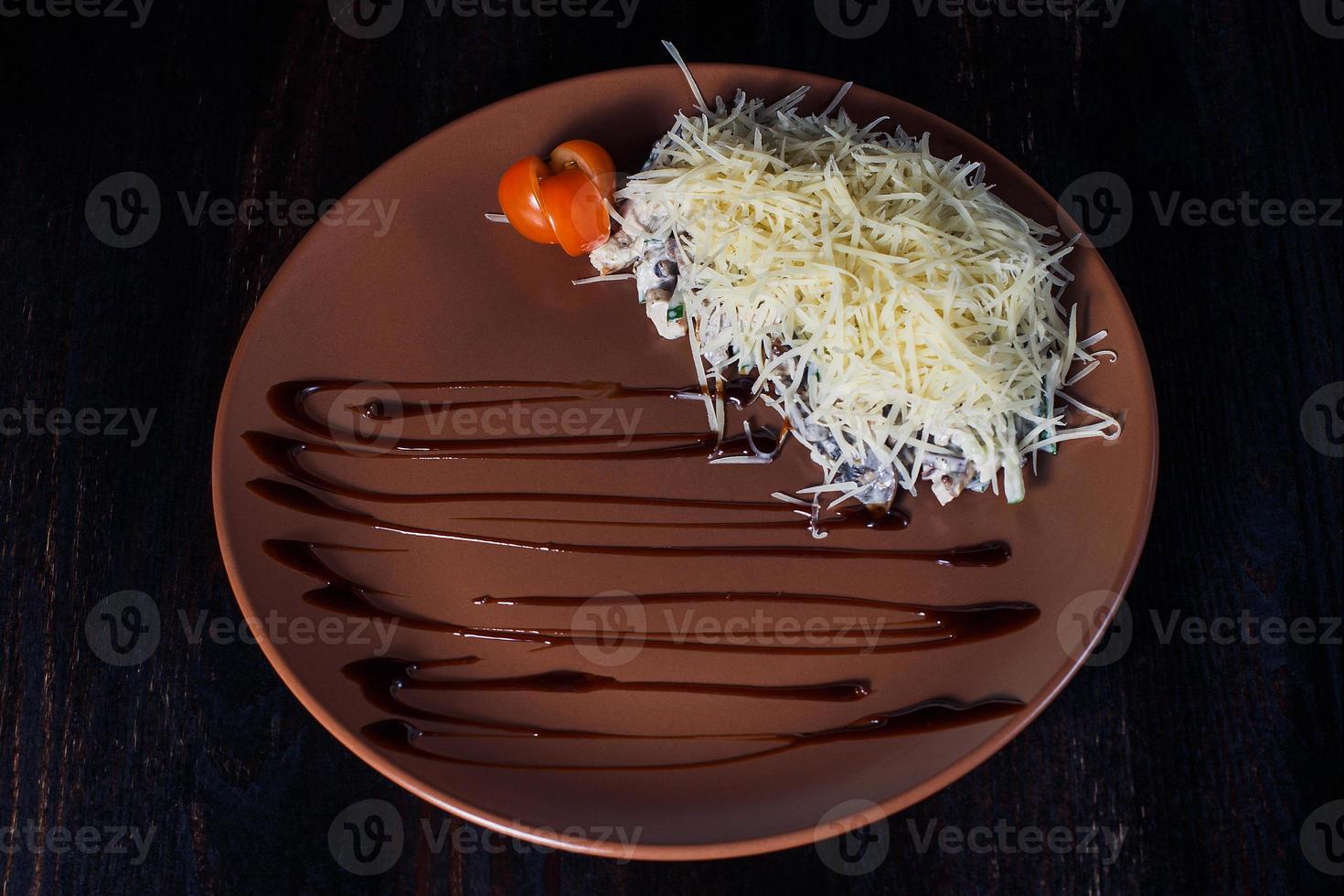 warm roast beef salad on a plate, beautiful serving, dark background photo
