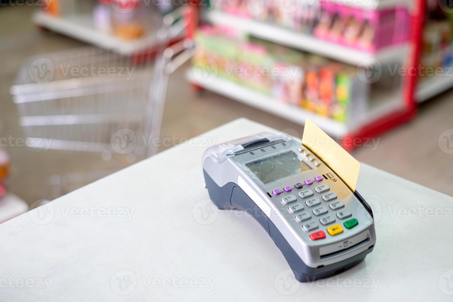 Using swiping credit card on payment terminal in store photo