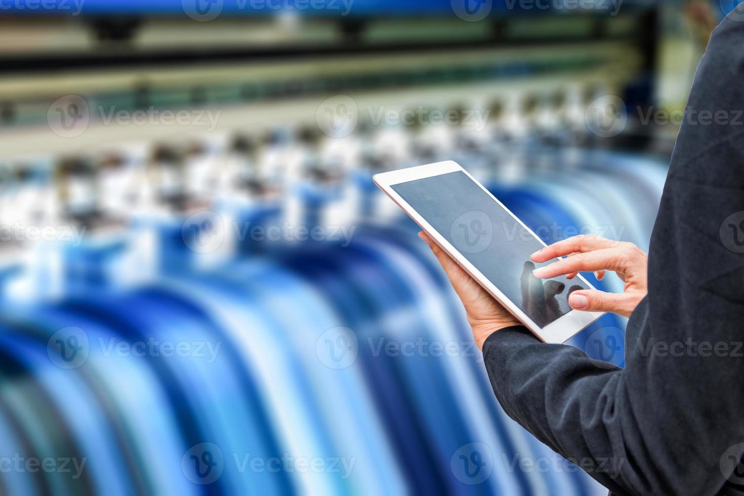 Technician using tablet control with format large inkjet printing blue plate photo