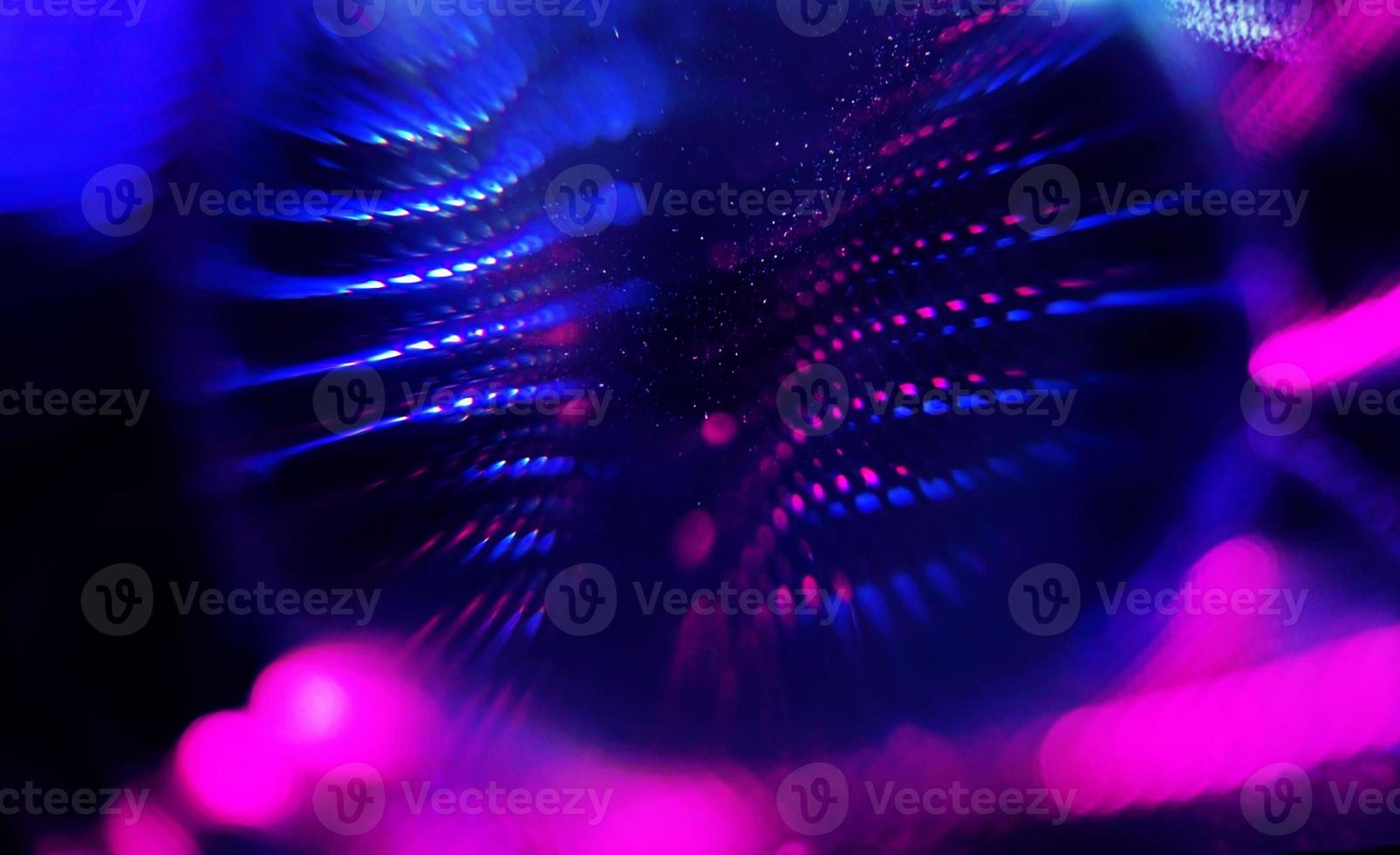 An amazing and beautiful macro of black clothes with pink and blue shine that seems like neon lights in night photo