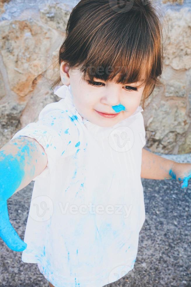Little girl dirty of paint photo