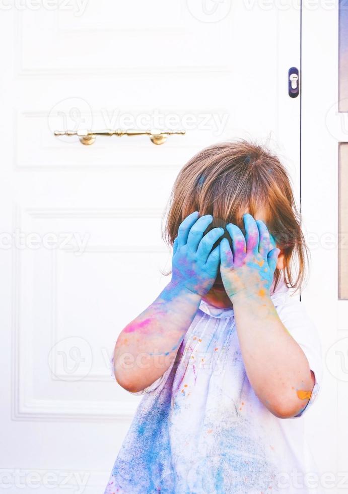 Little girl dirty of paint photo