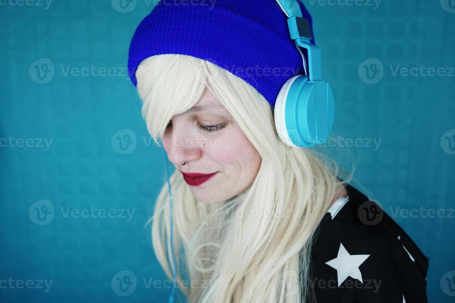 Beautiful blonde woman listening to music photo