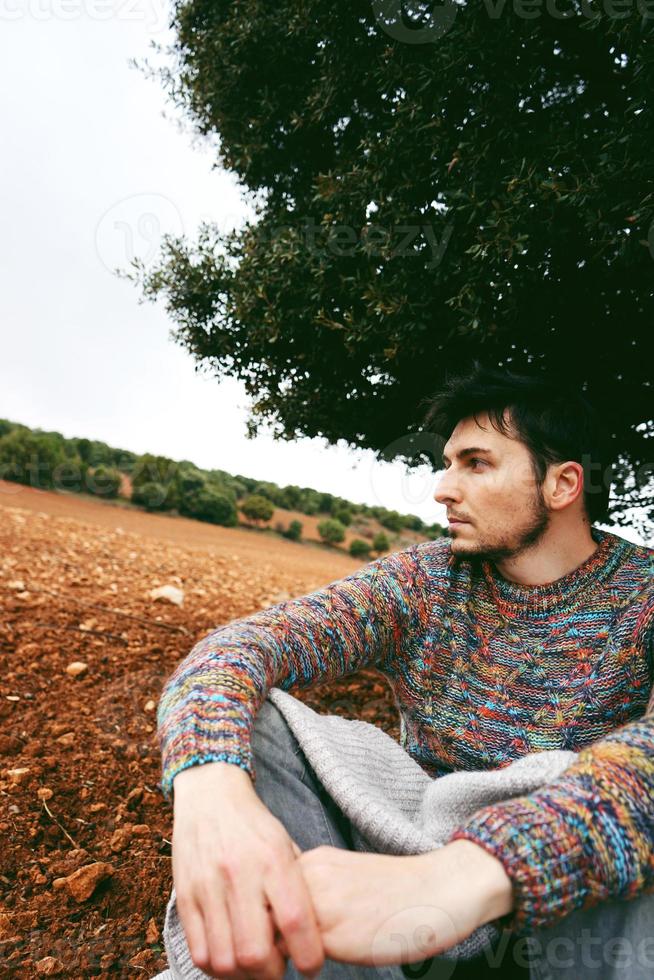 Young man alone and sad in nature photo