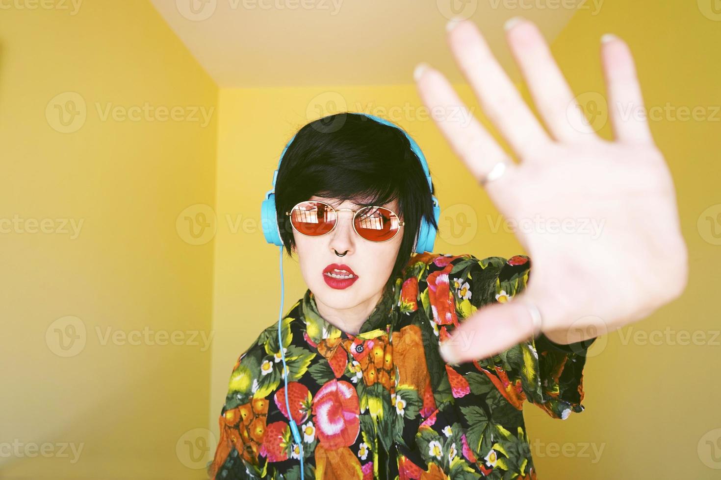 Cool androgynous dj woman in vibrant colors photo