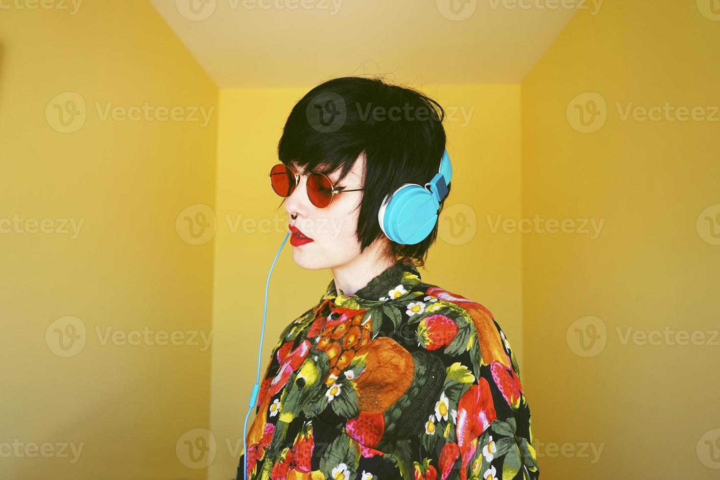 Cool androgynous dj woman in vibrant colors photo