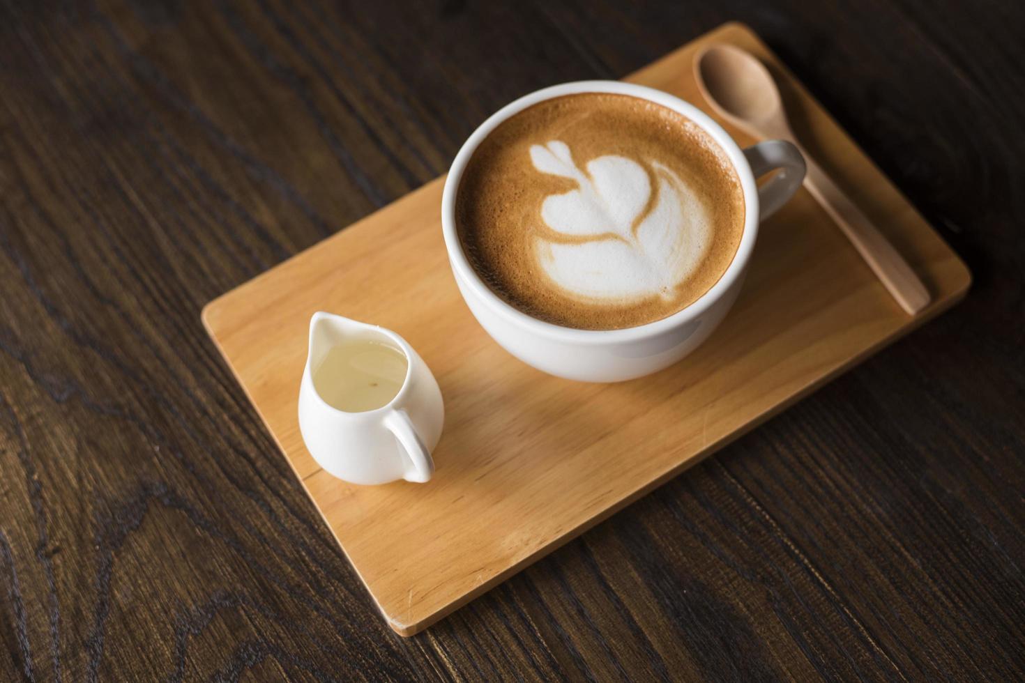 Hot latte art on wood table photo