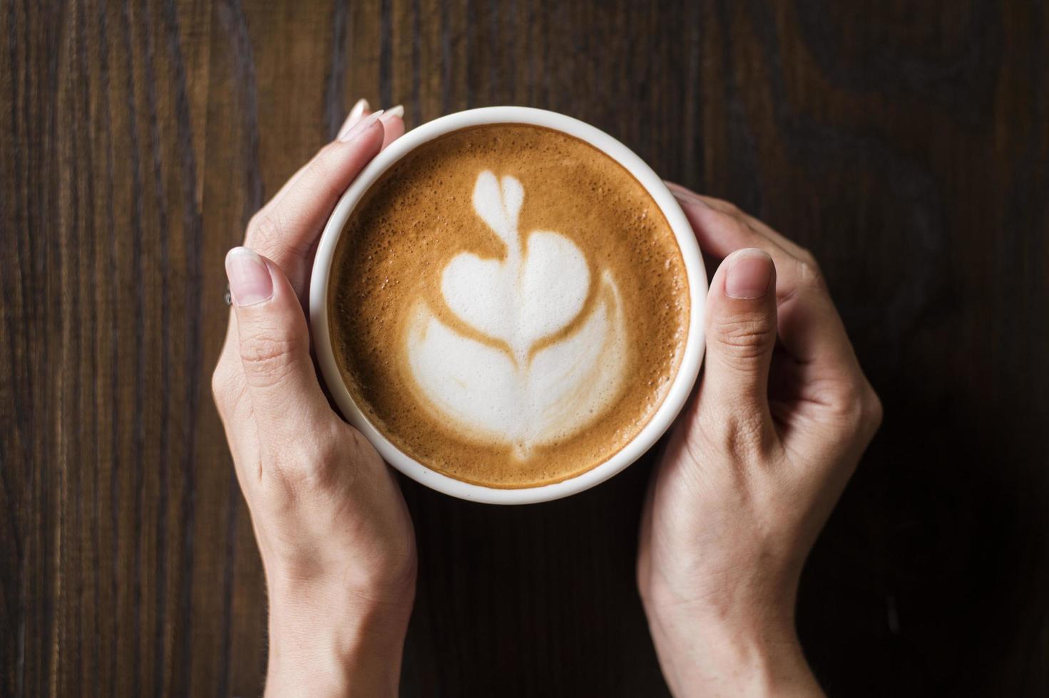 Hot latte art on wood table photo