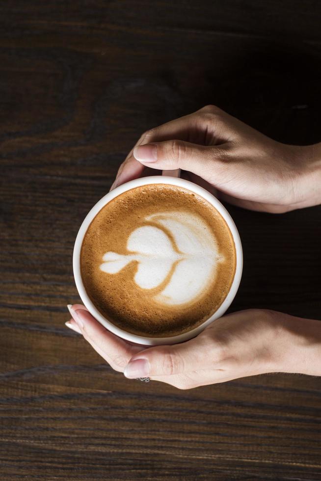 Hot latte art on wood table photo