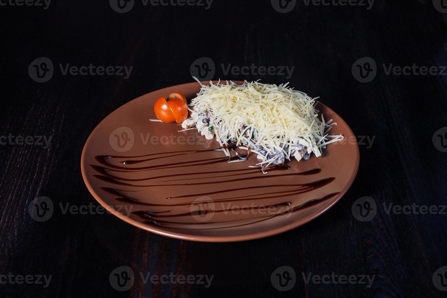 warm roast beef salad on a plate, beautiful serving, dark background photo