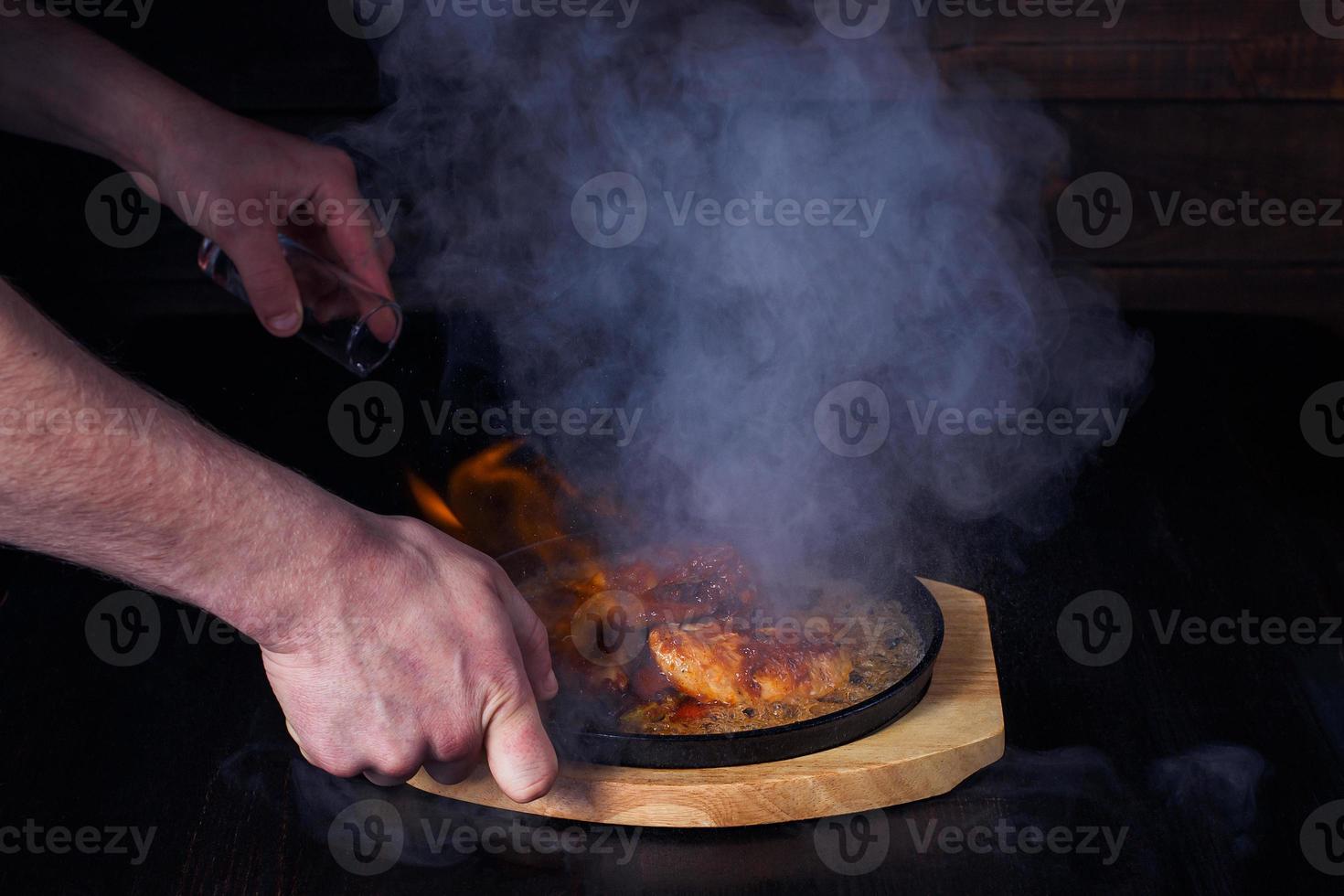 fajitos, meat in a frying pan with fire on a wooden tray, beautiful serving, dark background photo