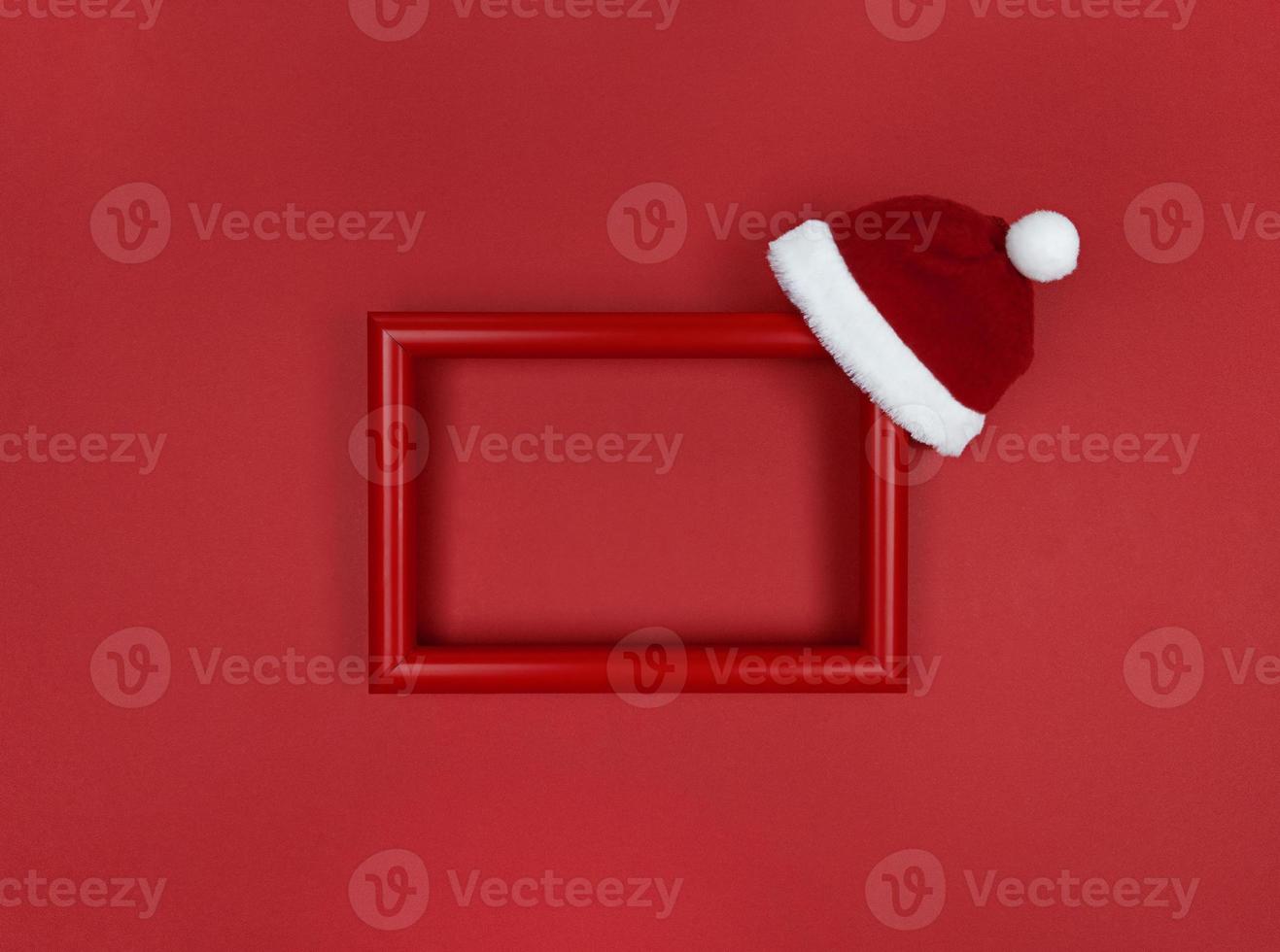 Frame and Santa hat on a red background. photo