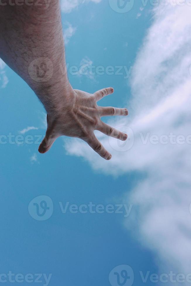 hand up reaching the blue sky photo