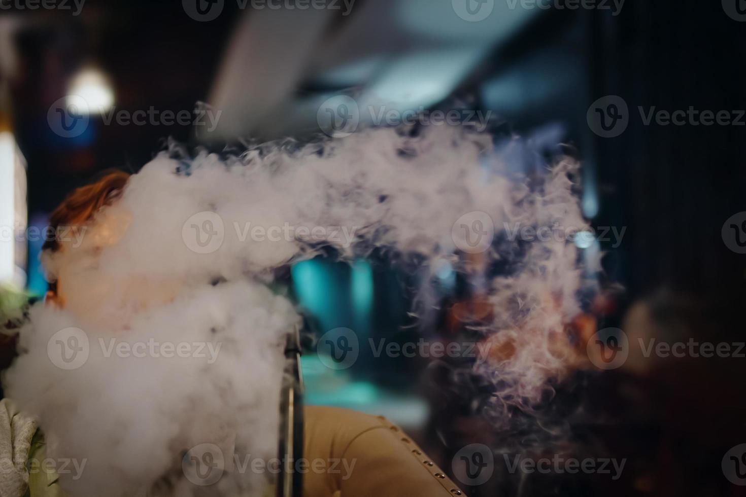 Man in restaurant smoking hookah. photo