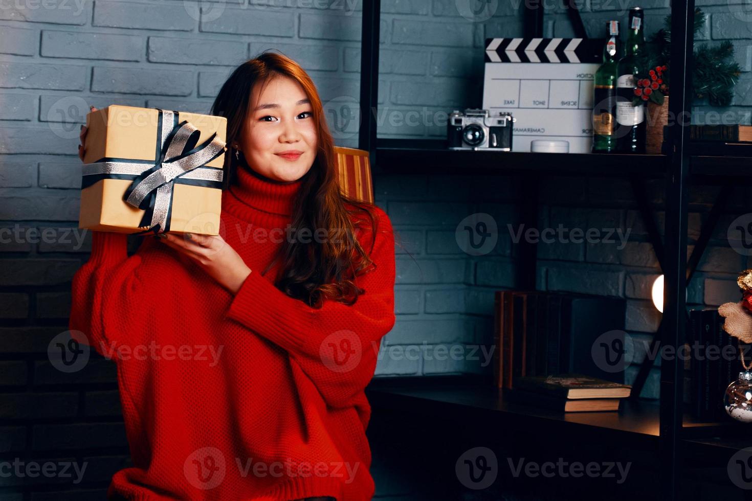 Asian girl with gift in her hands. photo