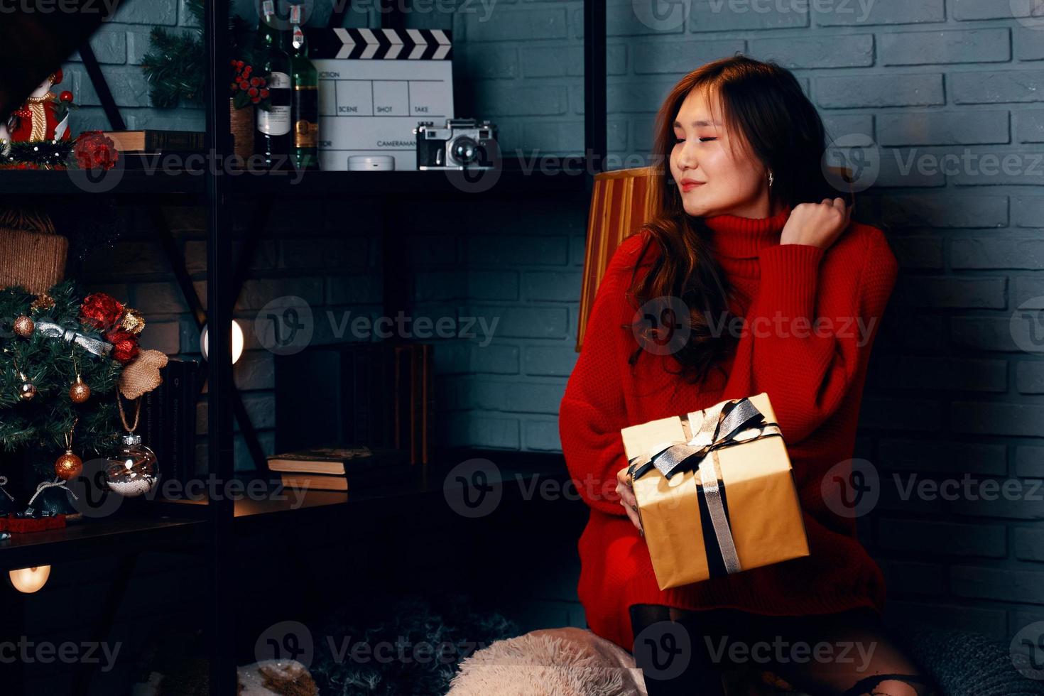 Asian girl with gift in her hands. photo