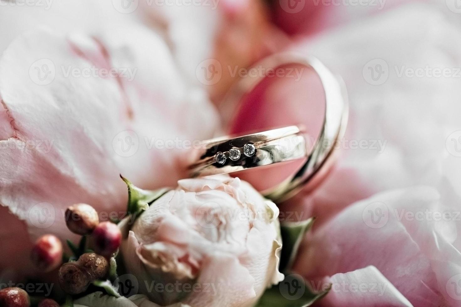 Wedding rings with a bouquet of flowers.Marriage proposal. Wedding photo