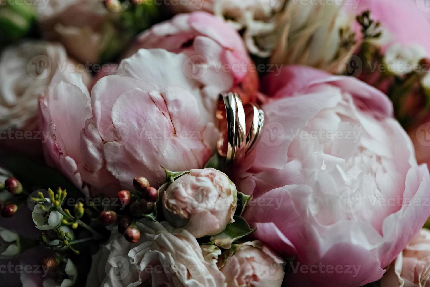 Wedding rings with a bouquet of flowers.Marriage proposal. Wedding photo