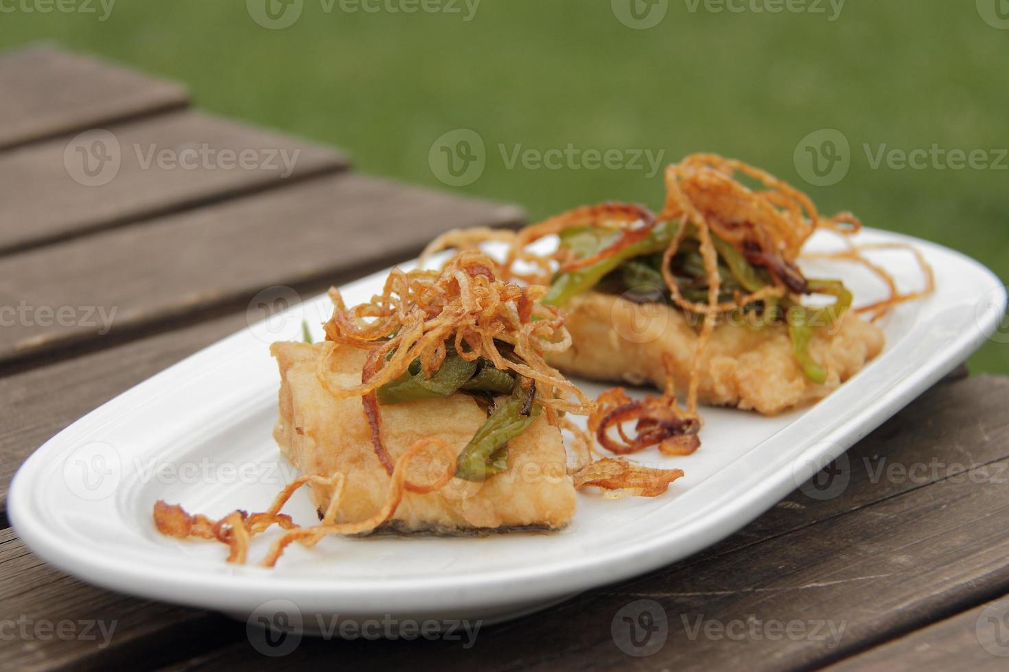 Cod fish bacalao cooked with fried onion photo