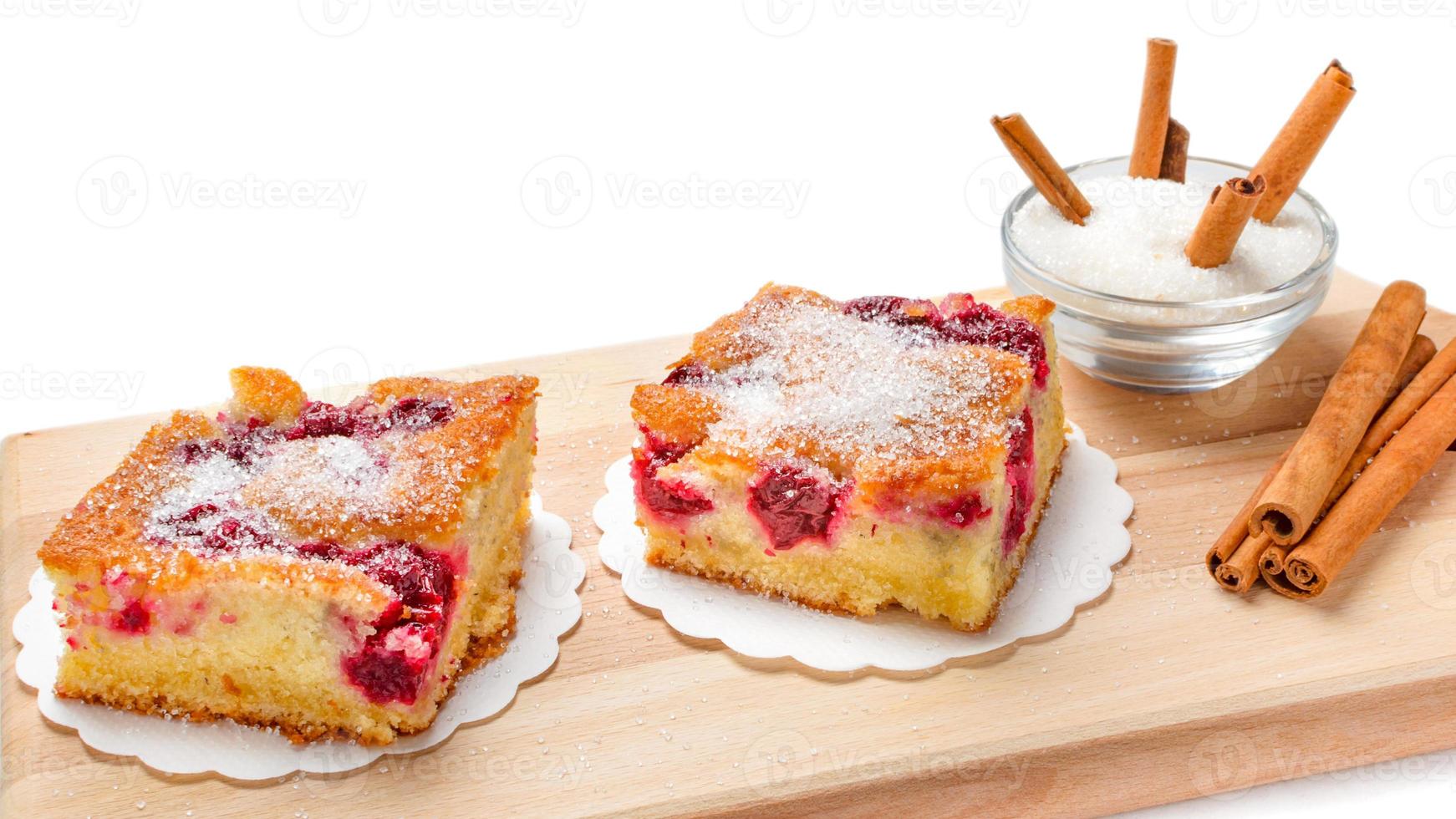 Sour cherry cake. Slices of sour cherry cake with sugar and cinnamon sticks. photo