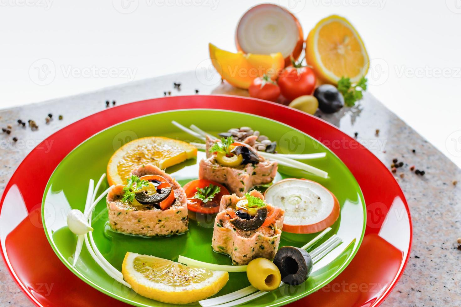 Cold appetizer. Tuna medallions with selection of fruits and vegetables photo