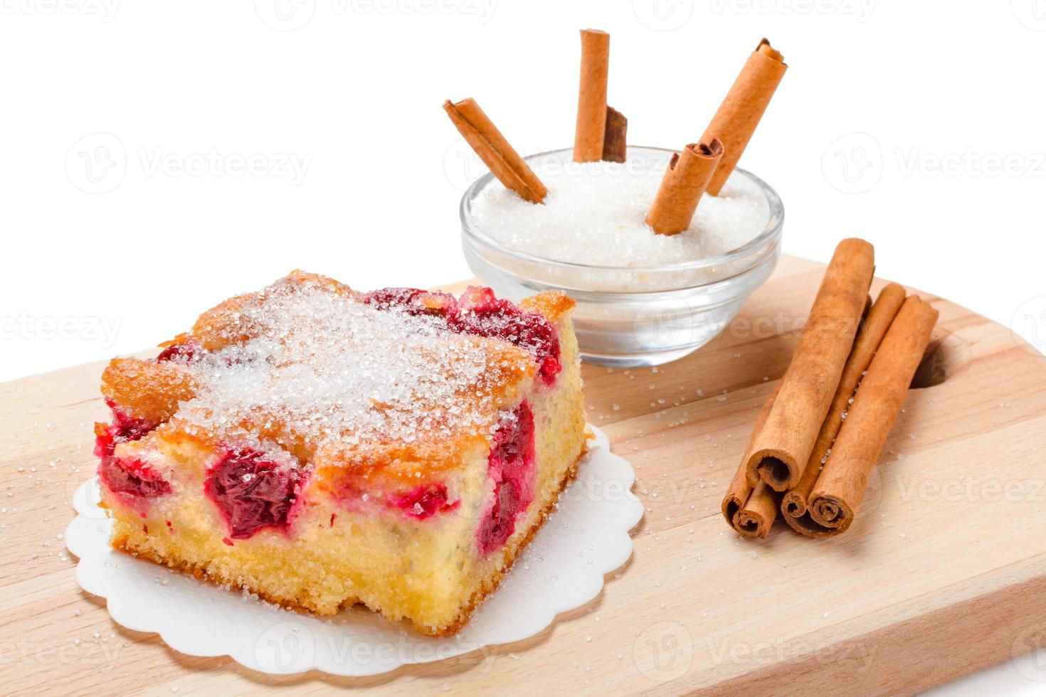 Sour cherry cake. Slices of sour cherry cake with sugar and cinnamon sticks. photo