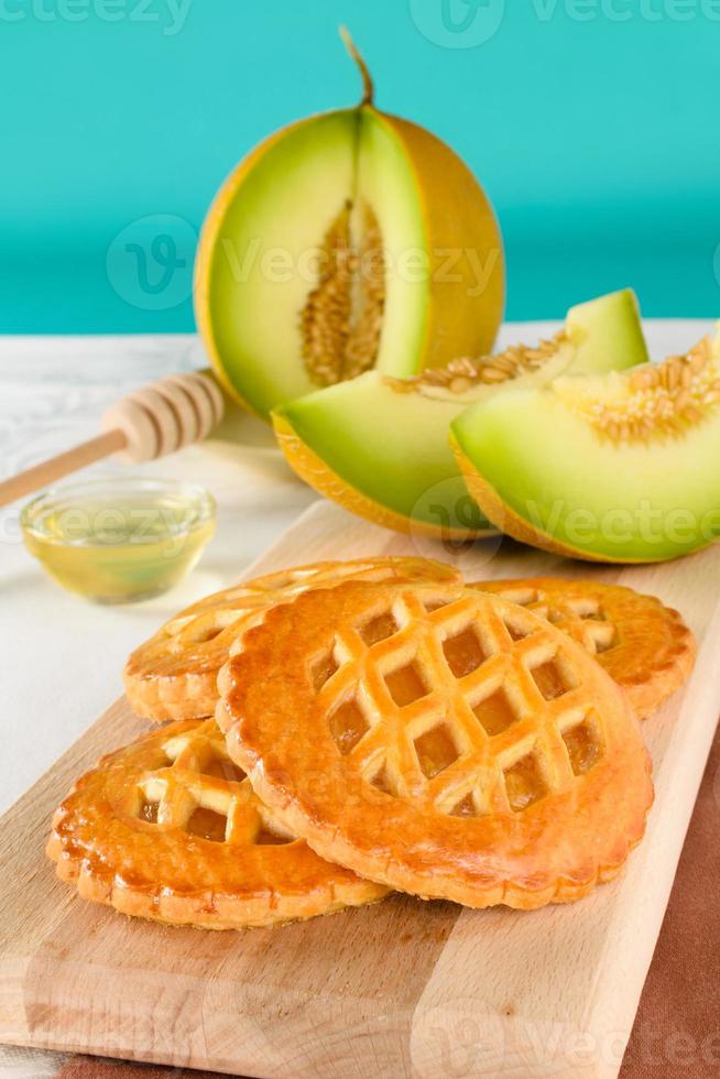 Melon cookies with honey. Fresh baked cookies filled with tasty homemade stuffing of melon. photo