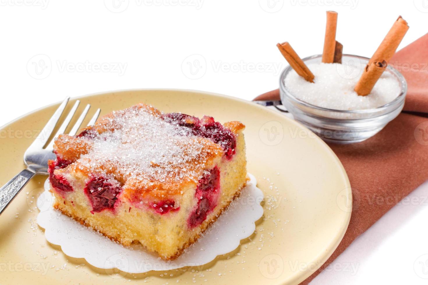Sour cherry cake. Slices of sour cherry cake with sugar and cinnamon sticks. photo