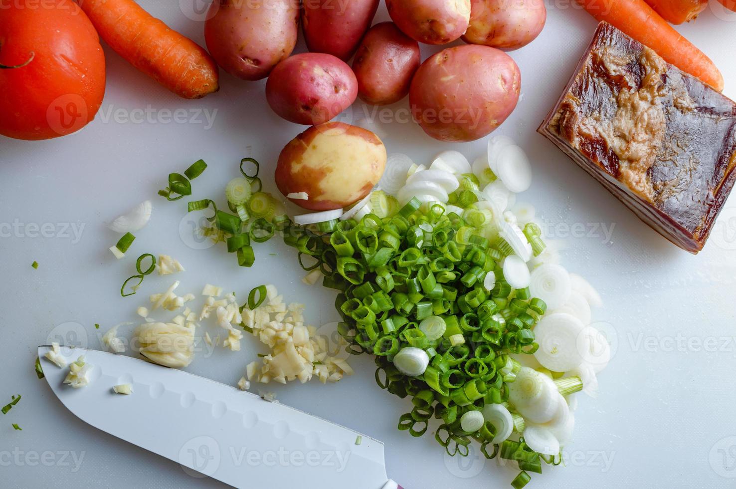 Spring vegetables and bacon on the kitchen table.Healthy foods are on the table. Homemade food preparation. photo