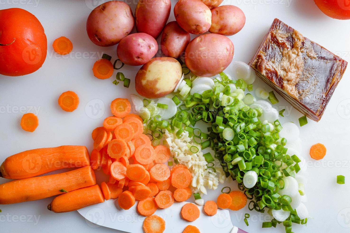 Spring vegetables and bacon on the kitchen table.Healthy foods are on the table. Homemade food preparation. photo