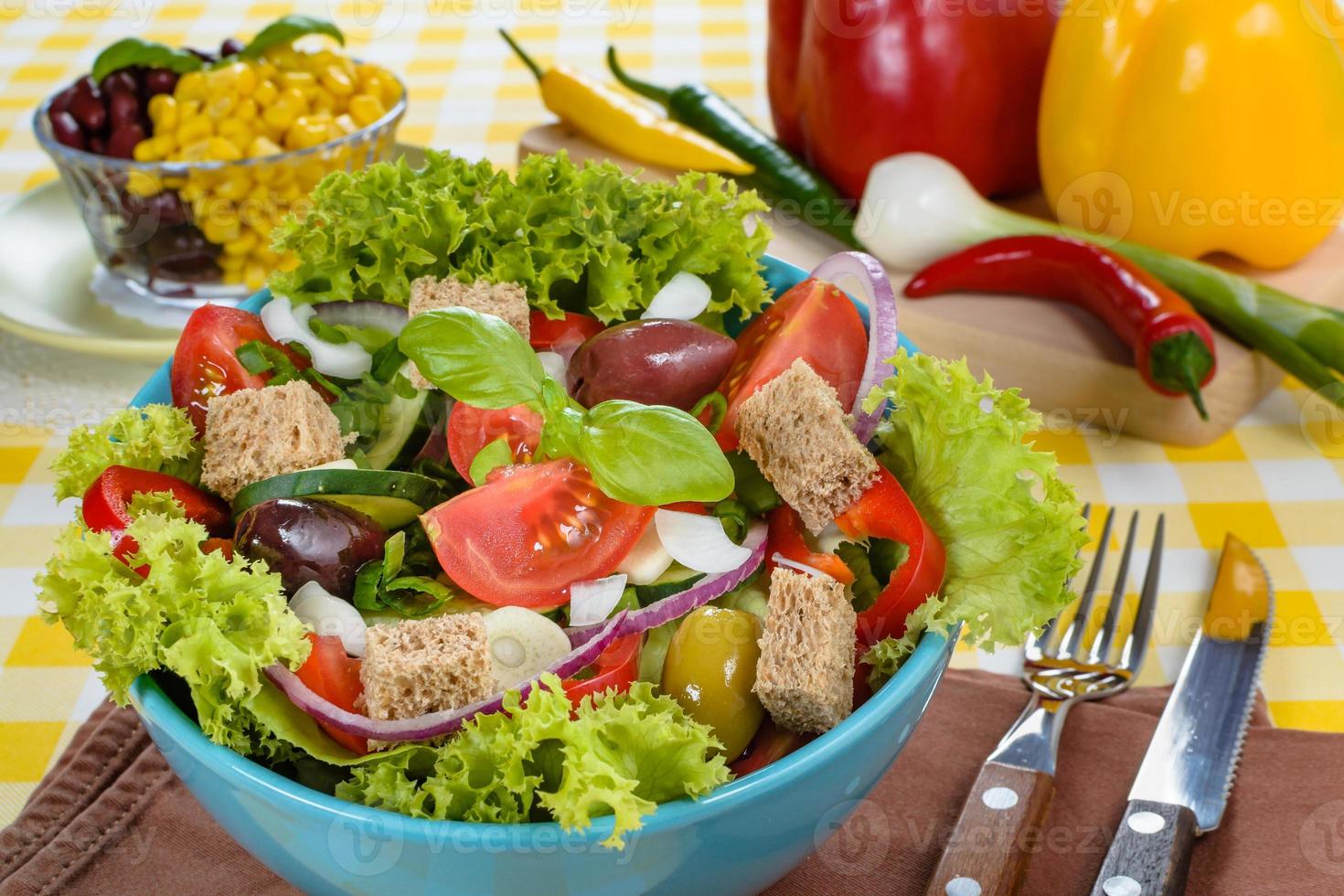 Fresh vitaminic green salad with bread cubes and tasty selection of vegetables. photo