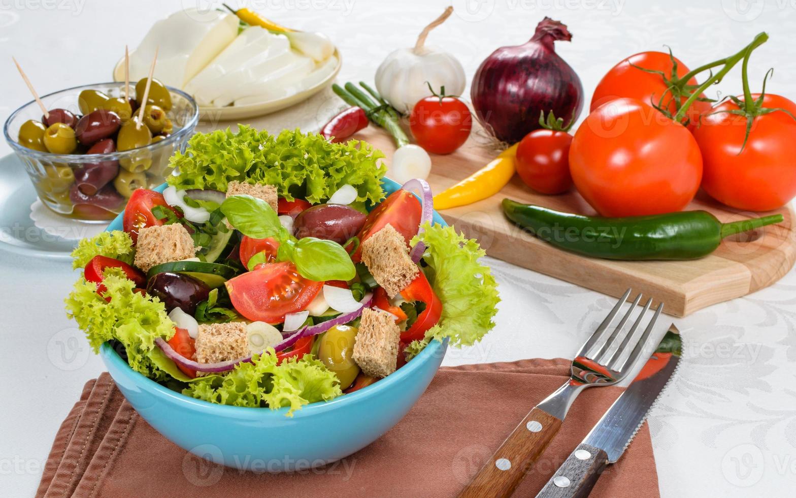 Fresh vitaminic green salad with bread cubes and tasty selection of vegetables. photo