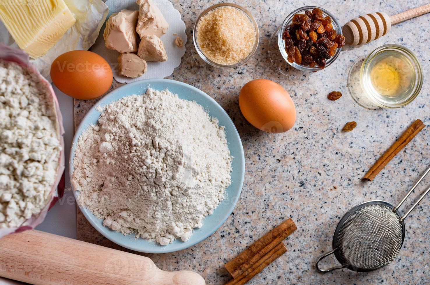 Ingredients for homemade dough, semisweet dough with raisins, honey and  various seeds. Homemade bread preparation. Top view. photo