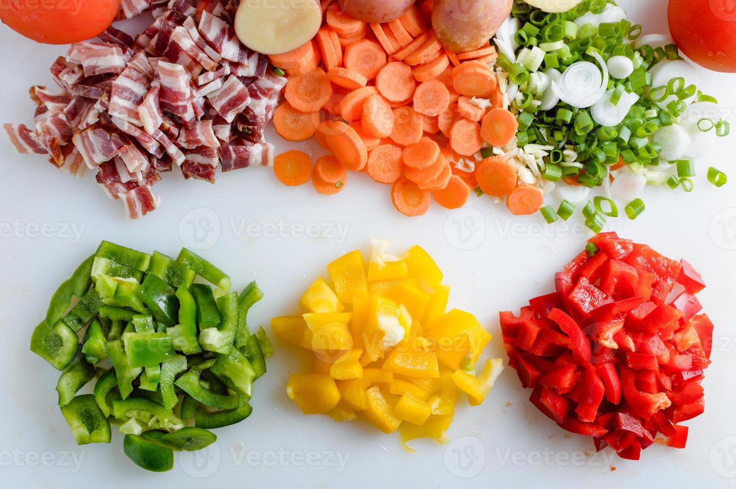 Spring vegetables and bacon on the kitchen table.Healthy foods are on the table. Homemade food preparation. photo