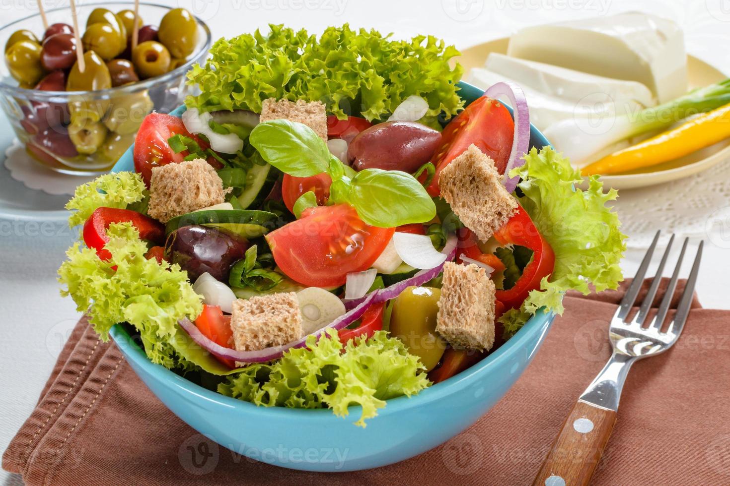 Fresh vitaminic green salad with bread cubes and tasty selection of vegetables. photo