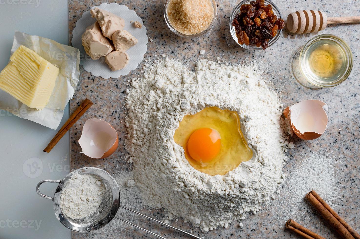 Ingredients for homemade dough, semisweet dough with raisins, honey and  various seeds. Homemade bread preparation. Top view. photo