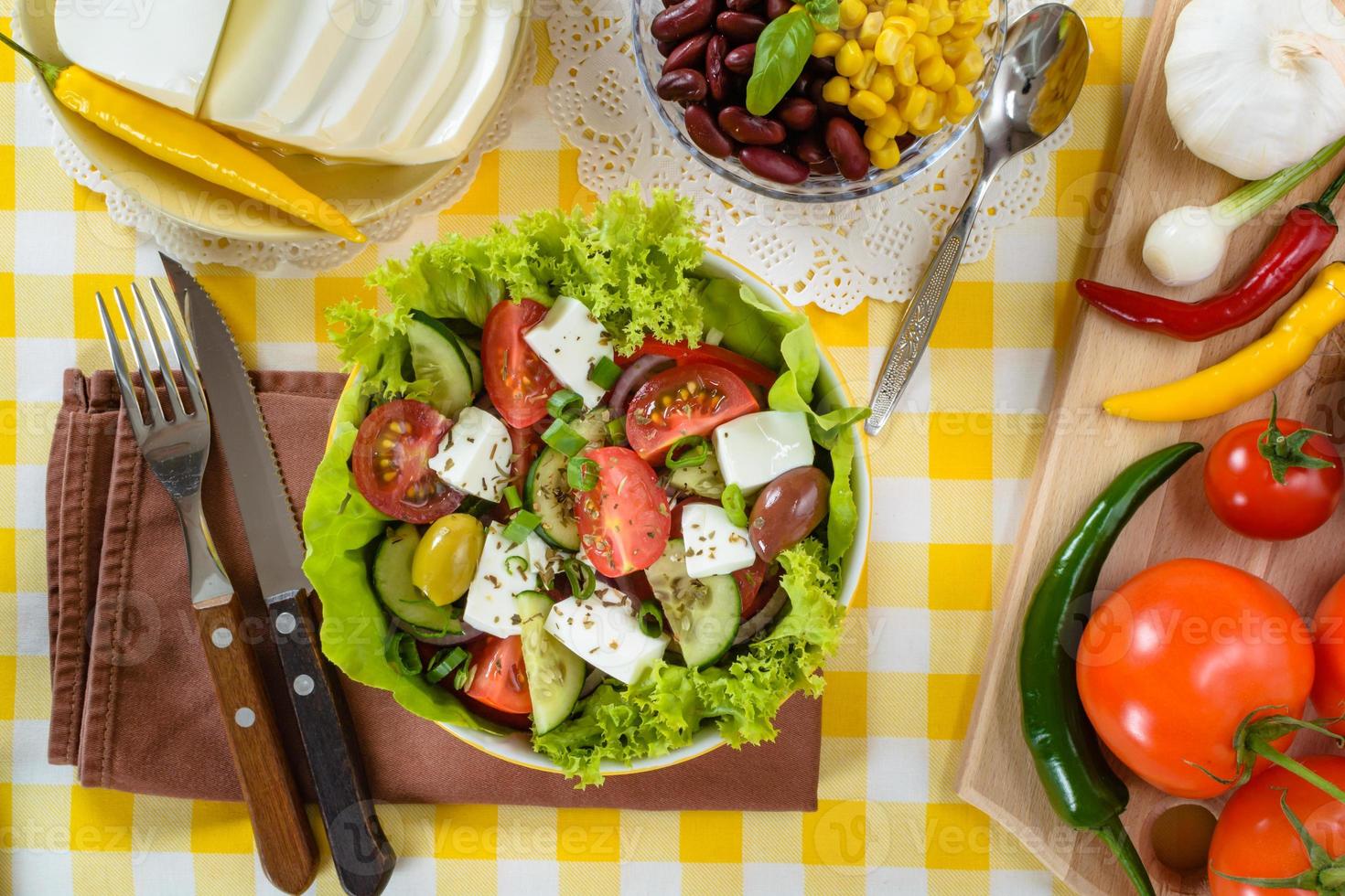 Greek salad with feta and tasty selection of vegetables. photo