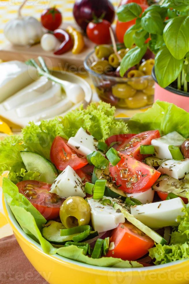 Greek salad with feta and tasty selection of vegetables. photo