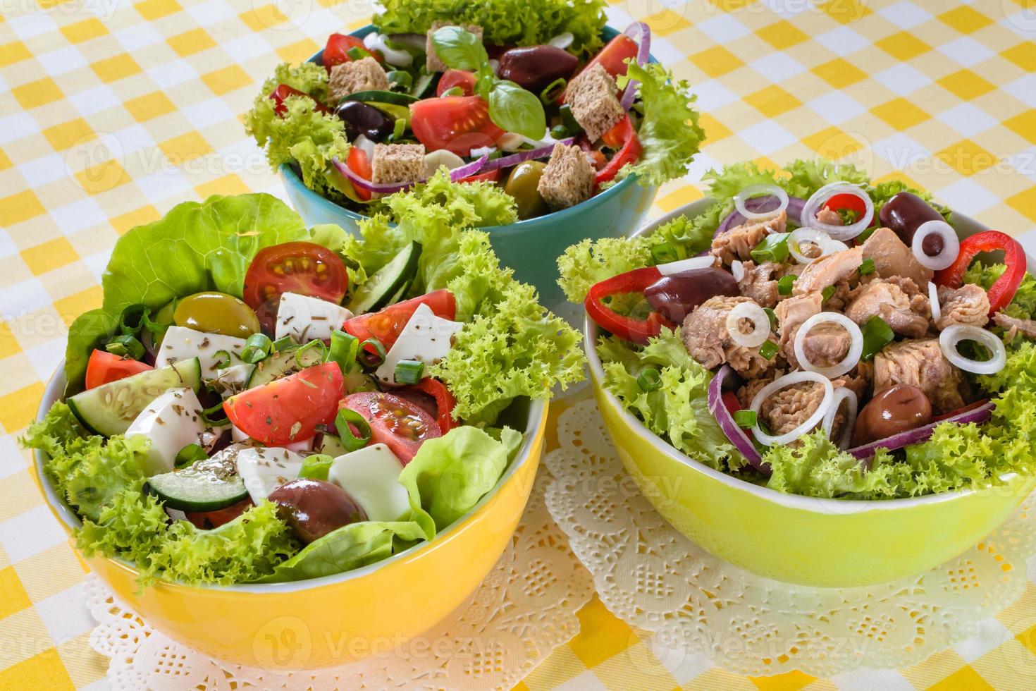 Tuna, Vitaminic green and Greek salad with feta and tasty selection of vegetables. photo