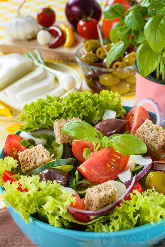Fresh vitaminic green salad with bread cubes and tasty selection of vegetables. photo