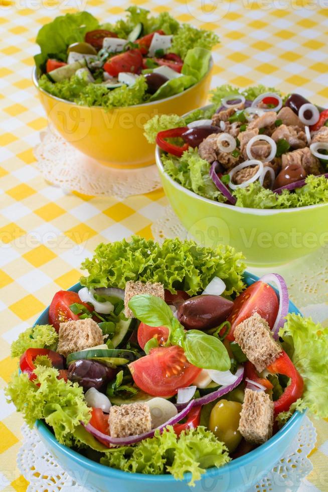 Tuna, Vitaminic green and Greek salad with feta and tasty selection of vegetables. photo