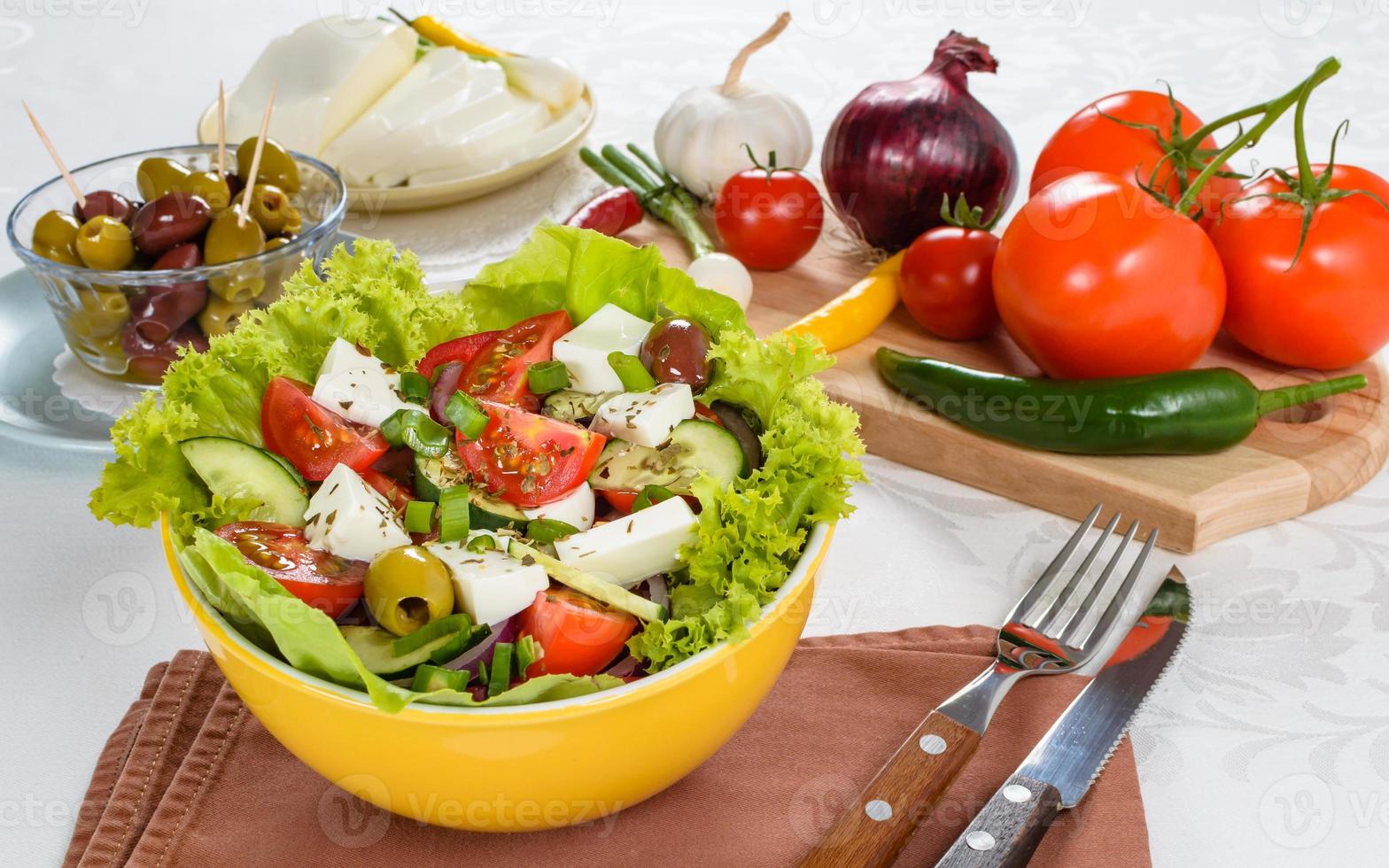 Greek salad with feta and tasty selection of vegetables. photo
