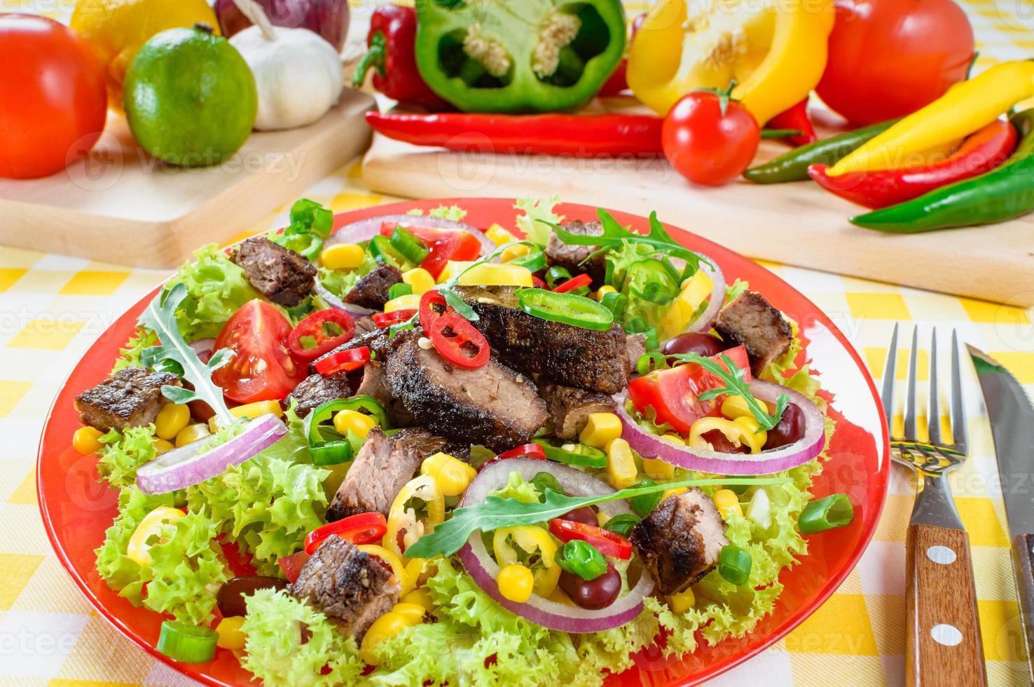 Mexican spicy beef salad on the plate. Grilled beef meat with tasty selection of vegetables. photo
