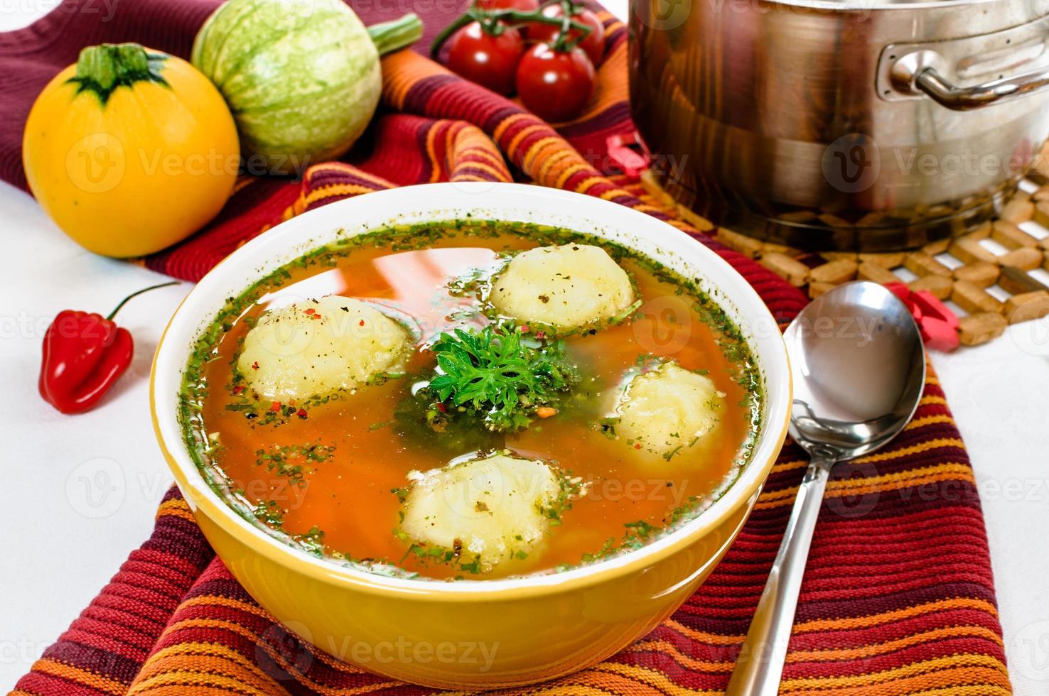 Vegetable soup with dumplings in the bowl. photo