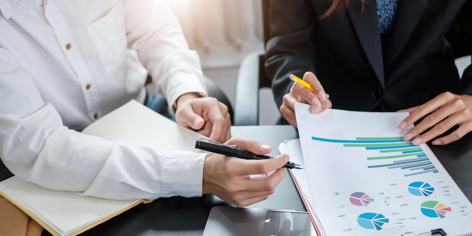 Close up of businesspeople meeting to discuss the situation in the market, business financial concept photo