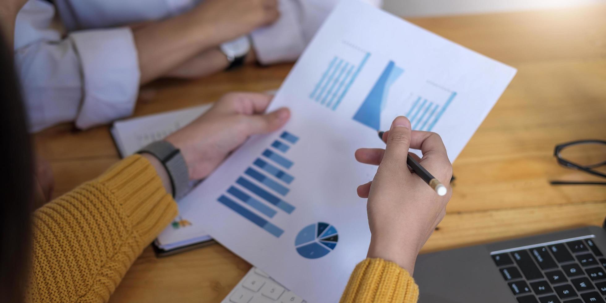 Close up of businesspeople meeting to discuss the situation in the market, business financial concept photo