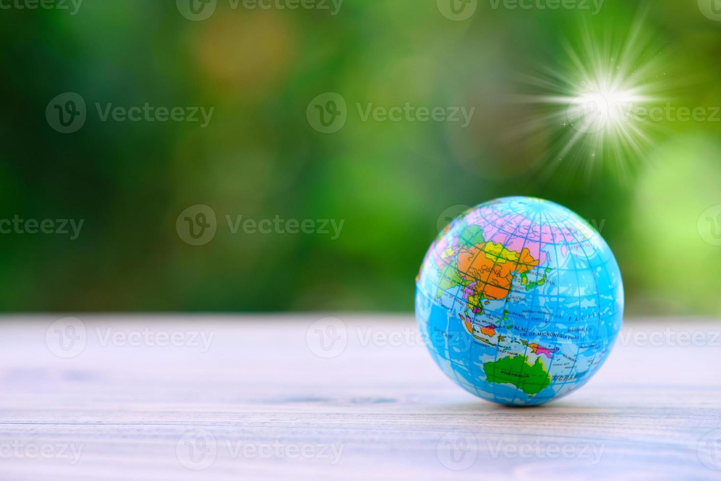Globe on wooden table background and space for text photo