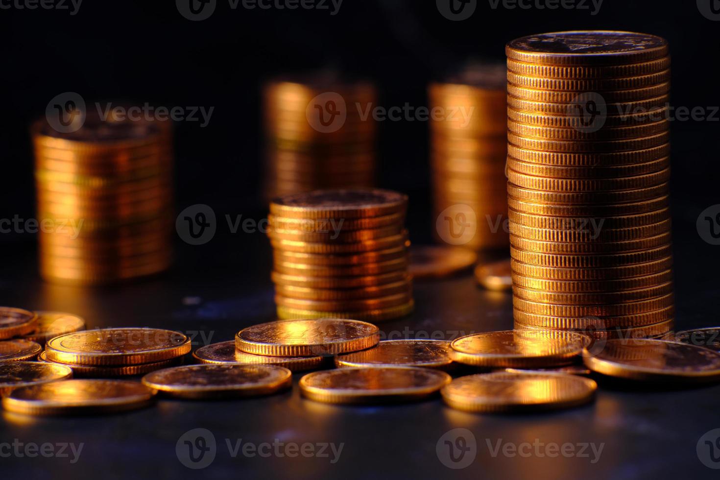 Stack of coins on a black background photo