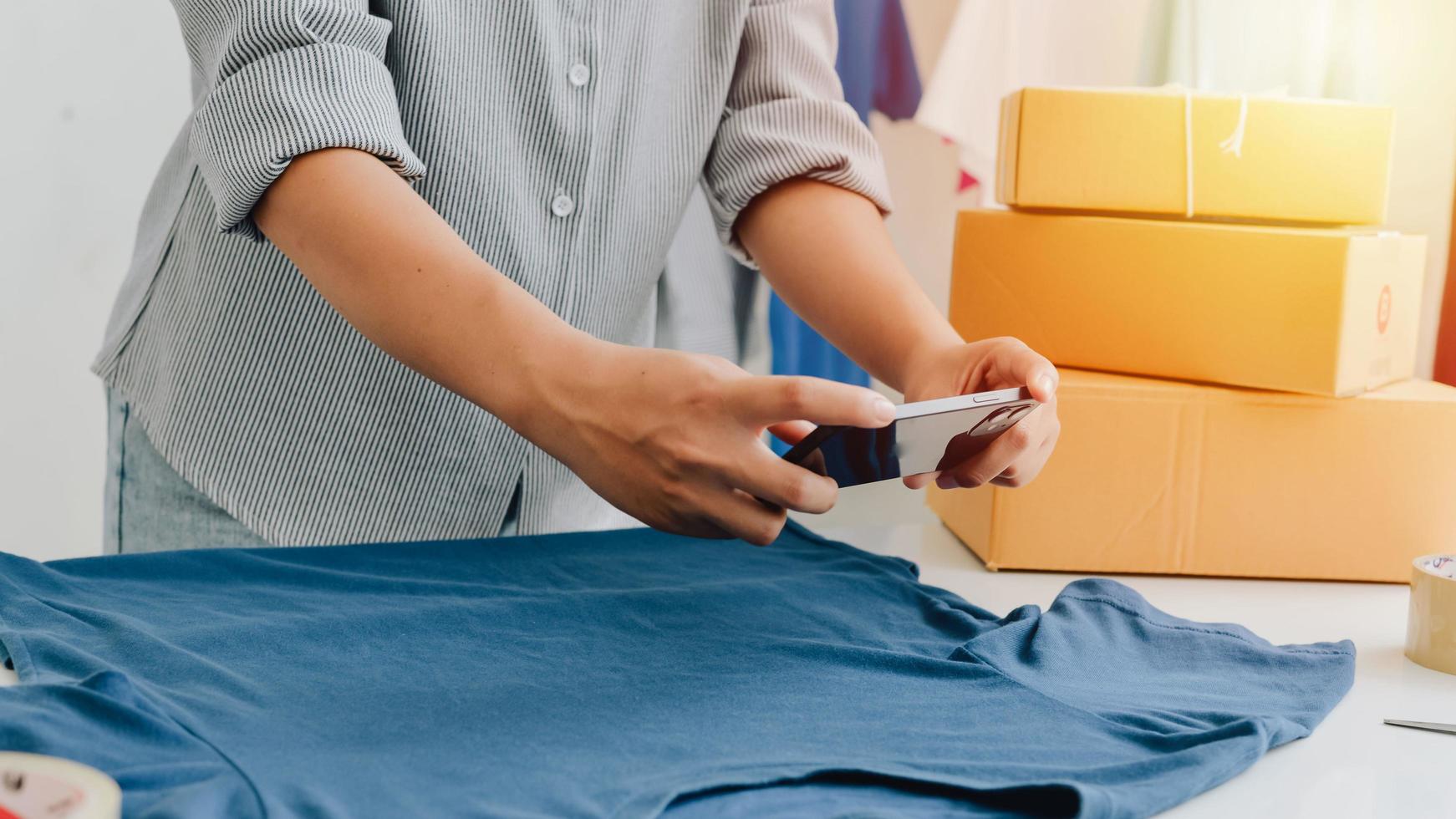 Closeup view of female's online store, small business owner seller, entrepreneur packing package, post shipping box preparing delivery parcel on the table, entrepreneurial self-employed business concept photo